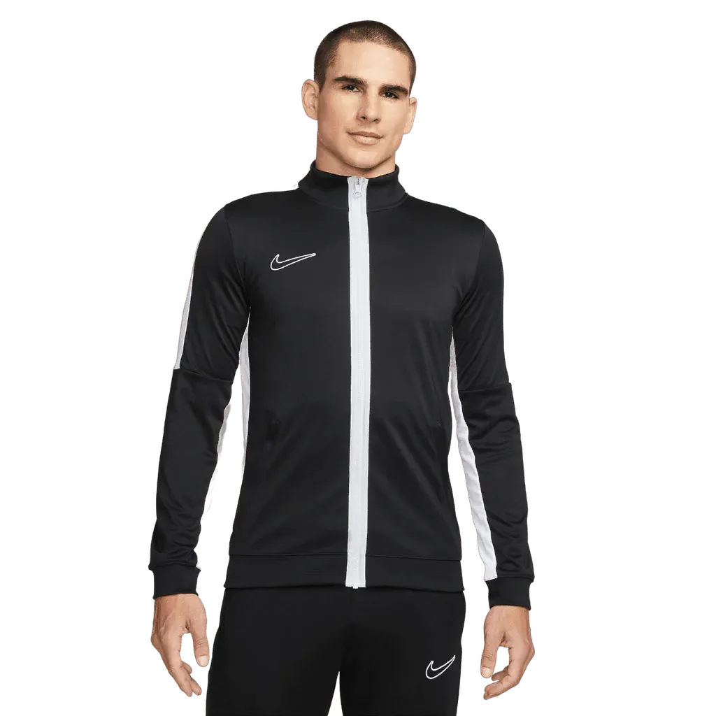 Man wearing a black and white Nike tracksuit on a white background